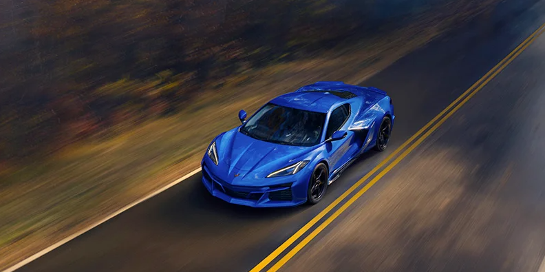 A 2025 Corvette E-Ray driving down the road.